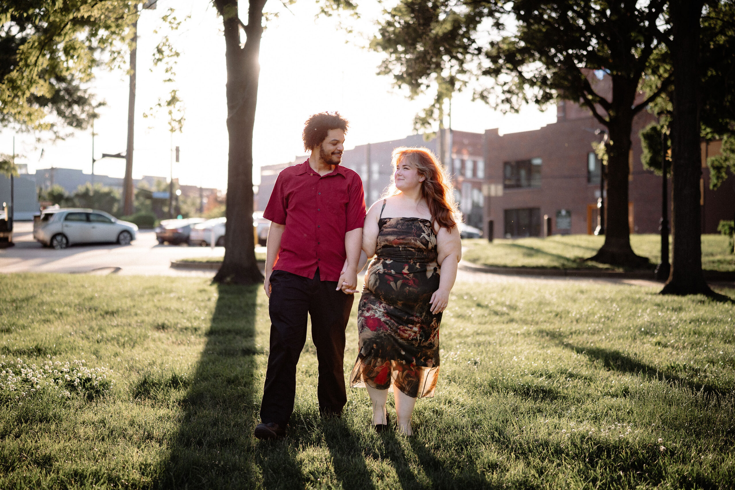 Darius and Josie standing in a forested area, both in wedding attire.