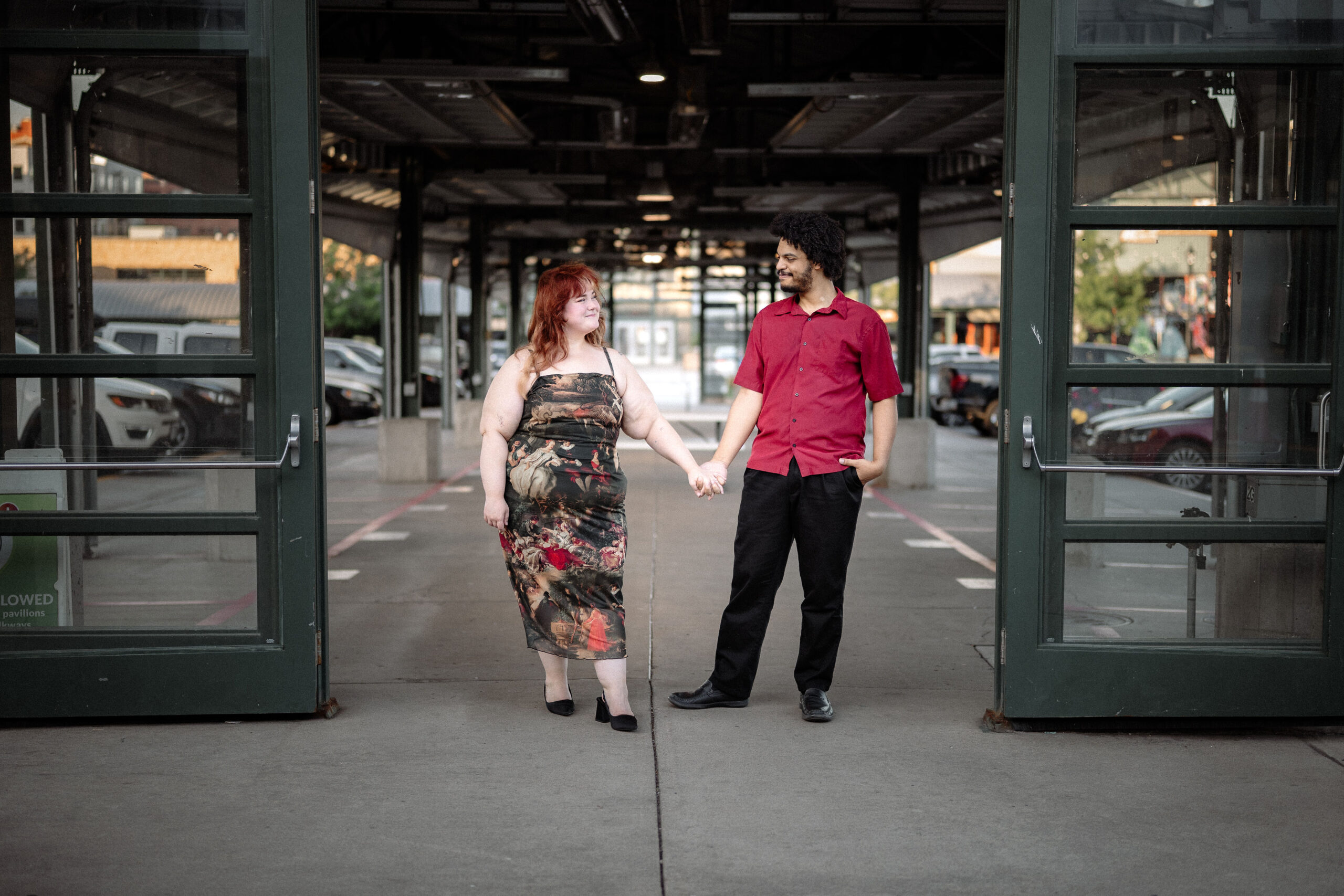 Darius and Josie standing close in a warmly lit indoor venue.